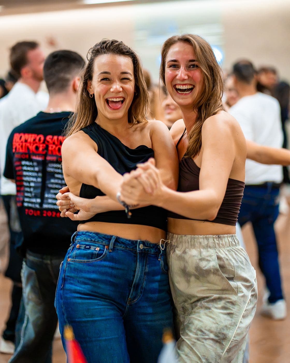 Two dancers laughing together during a workshop