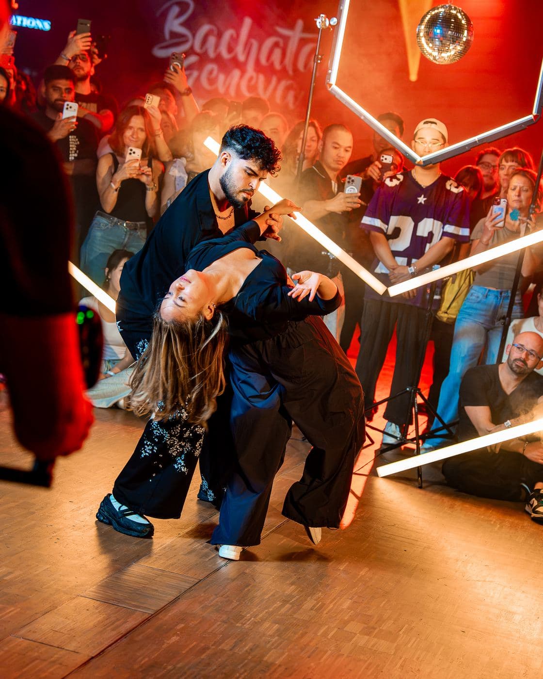 An artist dipping a partner during a workshop demo