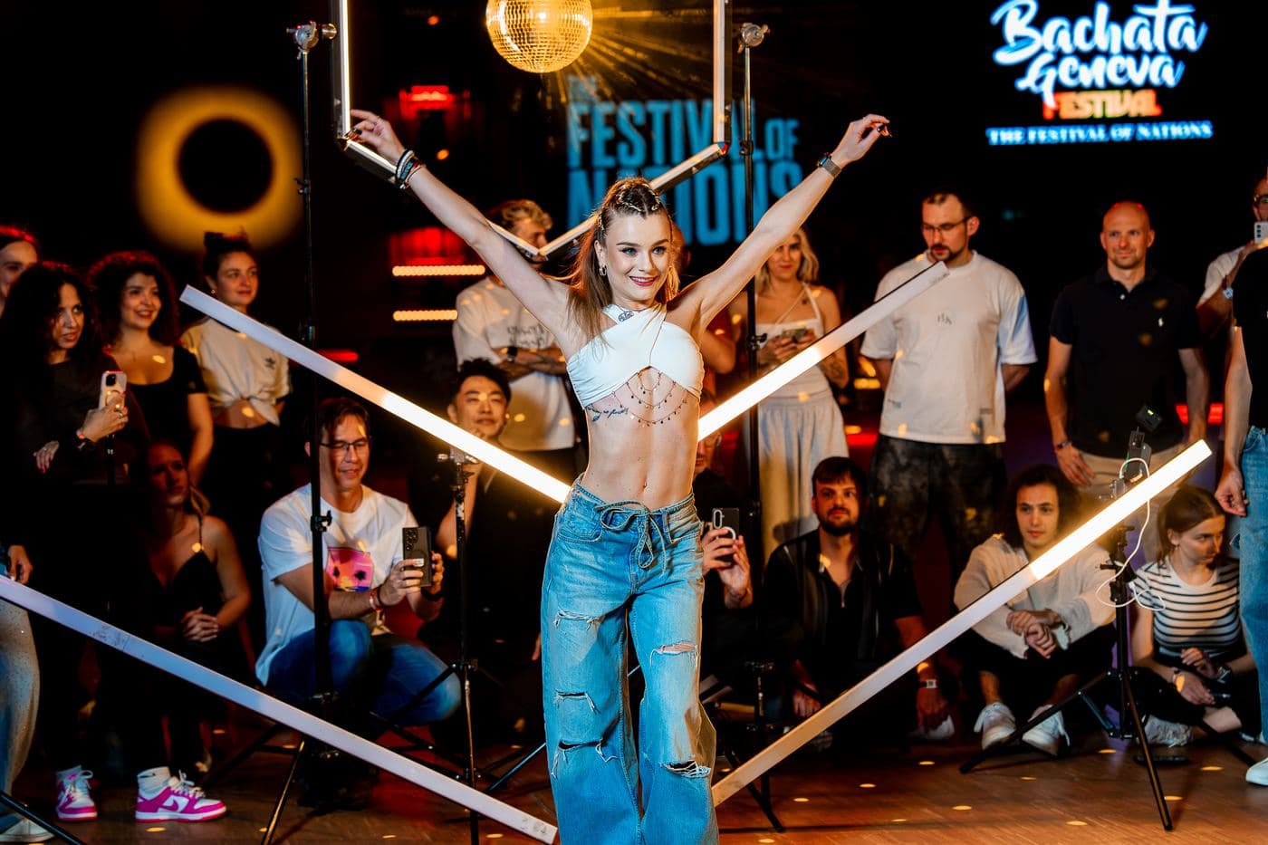 An artist posing between the light bars at the end of a workshop